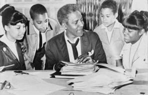 Baynard Rustin pictured with children around him.