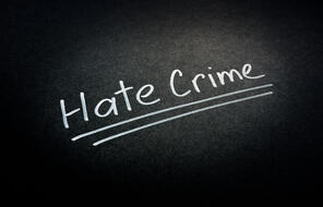 "Hate crime" words on a dark surface
