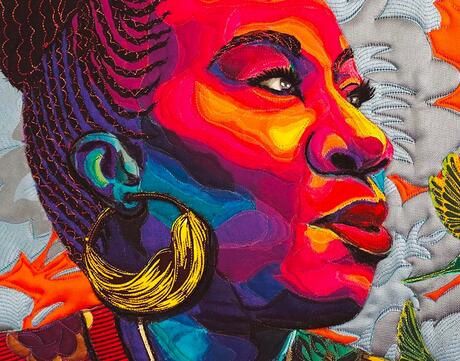 Colorful quilted portrait of activist Tarana Burke
