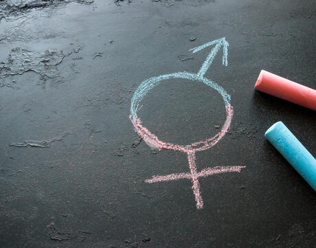 Pink and blue chalk with transgender symbol stock photo.