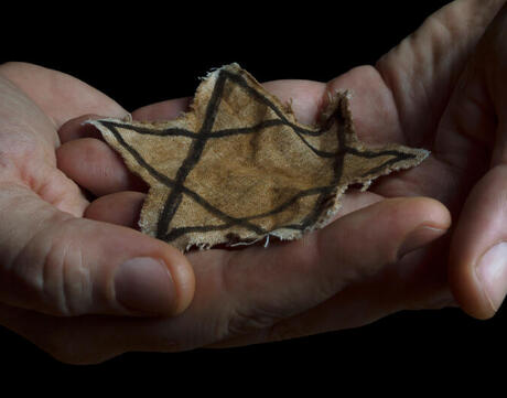 Jewish badge in the hands of a man stock photo.